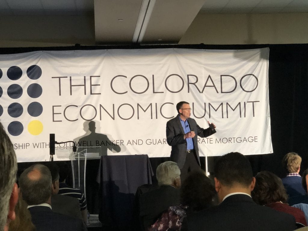 Speaker presentation at The Colorado Economic Summit with Real Property Management Colorado presenting to an audience