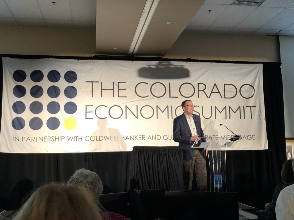 Greg Bacheller of Real Property Management Colorado presenting to an audience at The Colorado Economic Summit